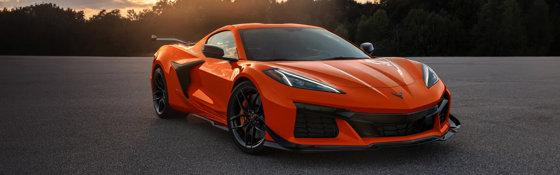 Orange 2026 Chevrolet Corvette Z06 sports car parked, showcasing its sleek design and aerodynamic features.
