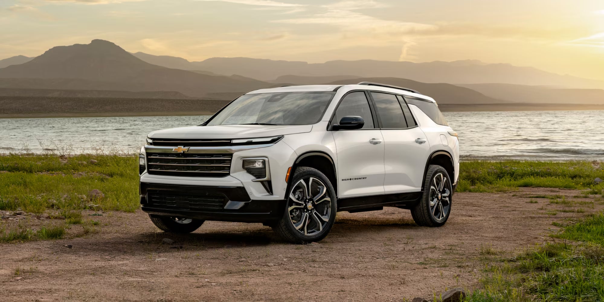 2027 Traverse parked on a dirt field in front of a lake